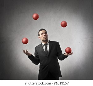 Businessman juggling with some balls