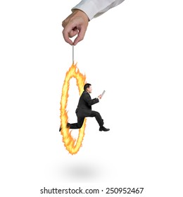 Businessman jumping through fire circle hand holding isolated on white background