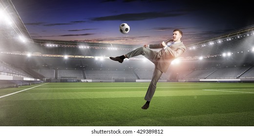 Businessman Kicking Ball