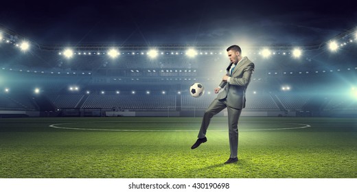 Businessman Kicking Ball