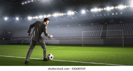 Businessman Kicking Ball