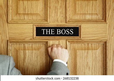 Businessman Knocking On A Door To 