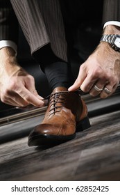 A Businessman Is Lacing His Shoes