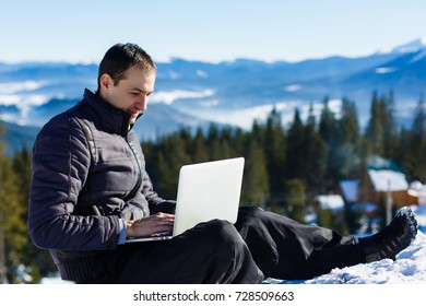 businessman with laptop in a snowy landscape