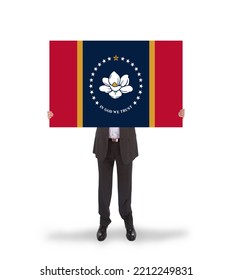 Businessman With A Large Message In His Hands - New Mississippi State Flag