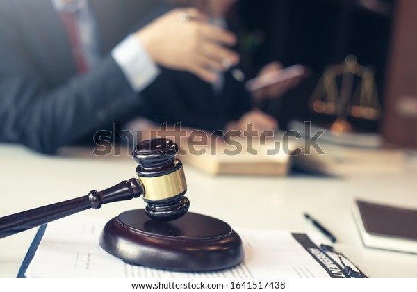 Businessman and lawyer discuss the\
contract document. Treaty of the law. Sign a contract\
business.