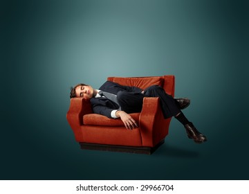 businessman laying on an armchair - Powered by Shutterstock