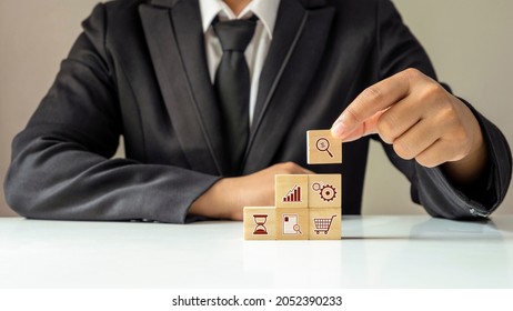 Businessman Laying Out The Financial Business Icon On The Wooden Cube, Financial Concept Business Growth, And Small Business Event Planning