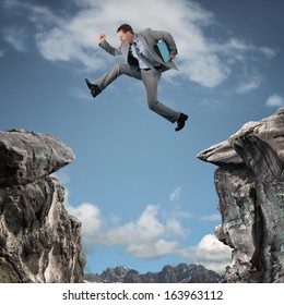 Businessman leap of faith concept for business adversity, risk or challenge