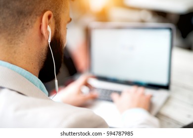 Businessman listening music working at the office. Business concept. Freelancer.