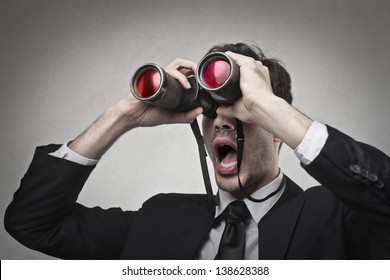 businessman looking with binoculars - Powered by Shutterstock