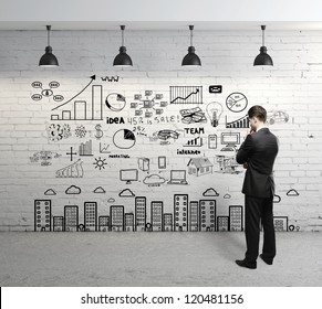 businessman looking at business concept on wall