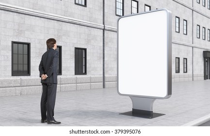 A Businessman Looking At A Citylight In The Street, City At Day Time. Side View. A House At The Background. Concept Of Street Advertising.