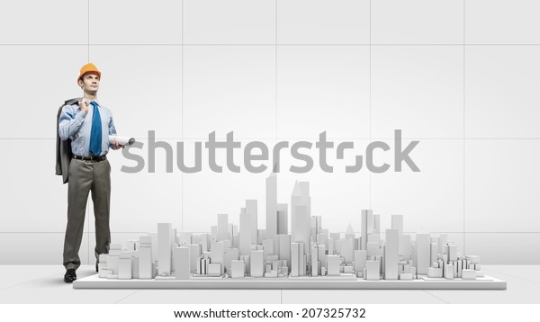 Businessman looking at digital construction project\
of modern city