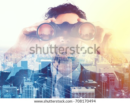 Businessman looking to the future with binoculars