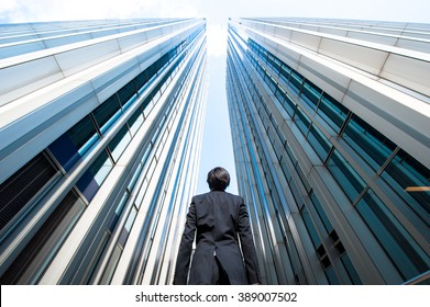 Businessman Looking Up At The High Building, Low Angle