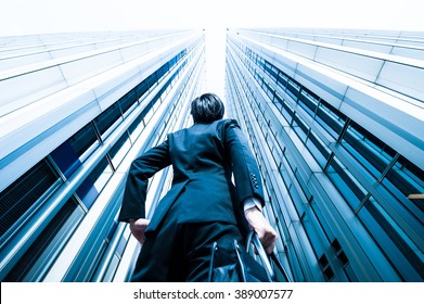 Businessman Looking Up At The High Building, Low Angle