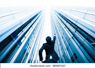 Businessman Looking Up At The High Building, Low Angle