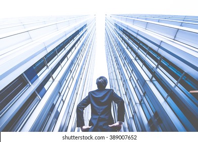 Businessman Looking Up At The High Building, Low Angle