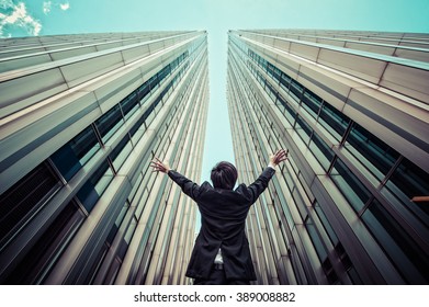 Businessman Looking Up At The High Building, Low Angle