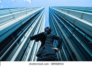 Businessman Looking Up At The High Building, Low Angle