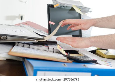 Businessman Looking For His Phone On His Messy Desk