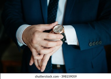 businessman looking at his watch on his hand, watching the time - Shutterstock ID 398159059