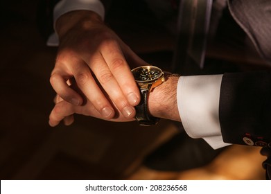Businessman looking at his watch punctuality
