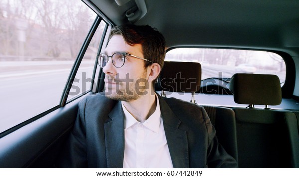 Businessman\
Looking With Interest Through a\
Window