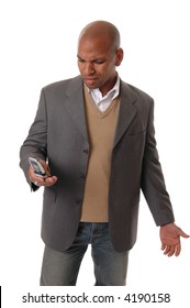 A Businessman Looking Irately At His Cell Phone Either Because Of A Caller Or The Device Is Malfunctioning