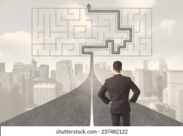Businessman looking at road with maze and solution concept