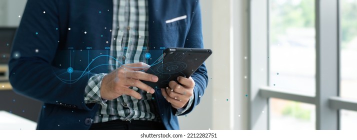 Businessman Looking At A Stock Market Volatility Graph On His Smartphone As A Photo Illustrating A Room With A Picture Of A Forums Icon In His Hand With Orange And White Flares.