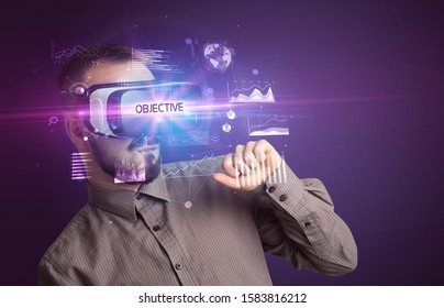 Businessman Looking Through Virtual Reality Glasses With OBJECTIVE Inscription, New Business Concept
