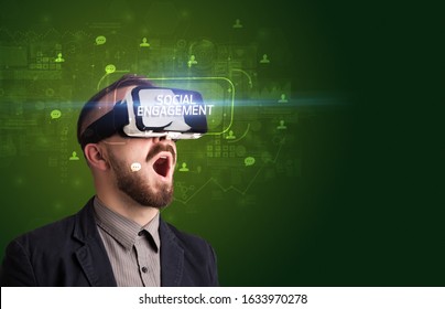 Businessman Looking Through Virtual Reality Glasses With SOCIAL ENGAGEMENT Inscription, Social Networking Concept