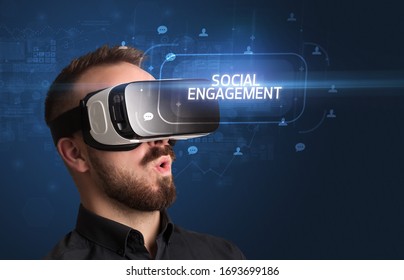 Businessman Looking Through Virtual Reality Glasses With SOCIAL ENGAGEMENT Inscription, Social Networking Concept