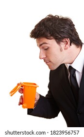 Businessman Looks Into A Small Garbage Can