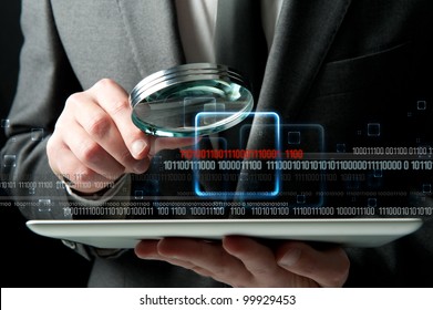 Businessman looks for the malicious code of a virus - Powered by Shutterstock