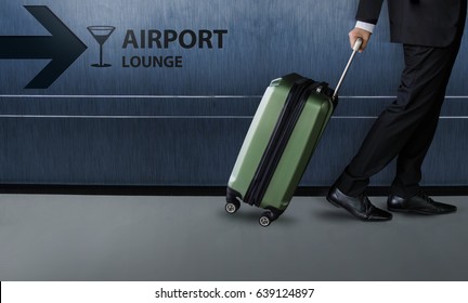 Businessman With Luggage Walk Inside Airport Departures Terminal, Exclusive Business Trip Flight Concept, Dark Blue Wall With Lounge Sign As Background