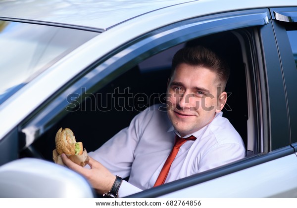 Businessman lunching in the\
car.