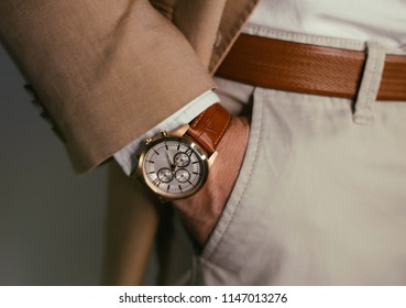 Businessman Luxury Style. Men Style.closeup Fashion Image Of Luxury Watch On Wrist Of Man.body Detail Of A Business Man.Man's Hand In A Beige Shirt With Cufflinks In A Pants Pocket Closeup. Toned