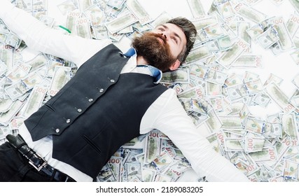 Businessman lying in many banknotes. Saving money. Business success. Rich millionaire, billionaire. - Shutterstock ID 2189083205