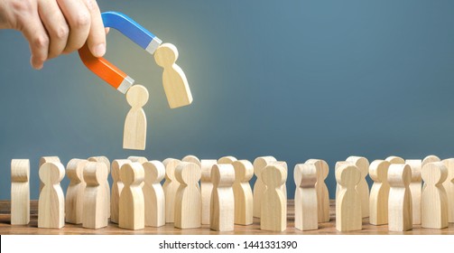 Businessman with a magnet pulls wooden figures of people out of big crowd. Recruiting workers. Formation of a new team. Search for required people and workers with the necessary talents and skills - Shutterstock ID 1441331390