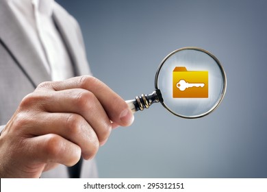 Businessman with magnifying glass over file, folder or document icon concept for security inspection, protection and confidential data
