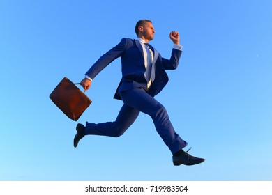 Businessman Makes Big Step Up On Career Ladder. Business And Success Concept. Run To Success Project Manager With Strict Face Expression. Man In Formal Suit Hold Case And Jumps Up Blue Sky Background.