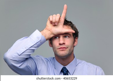 Businessman Making A Loser Gesture With His Hand