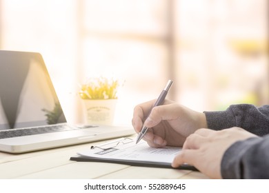 Businessman making notes at the office meeting with computer laptop and glasses. - Powered by Shutterstock