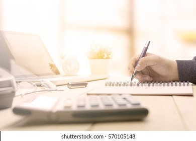 Businessman making notes at the office meeting with computer laptop and glasses. - Shutterstock ID 570105148