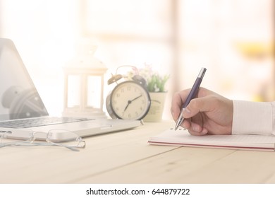 Businessman making notes at the office meeting with computer laptop and glasses. - Powered by Shutterstock