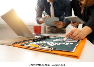 Businessman making presentation with his colleagues and business tablet digital computer at the office as concept in morning light
