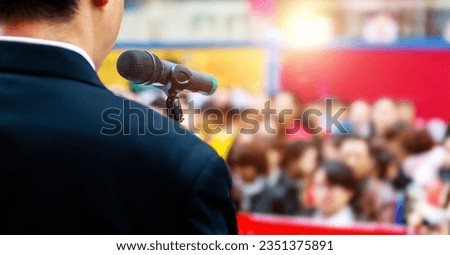 Businessman making a speech in front of crowds